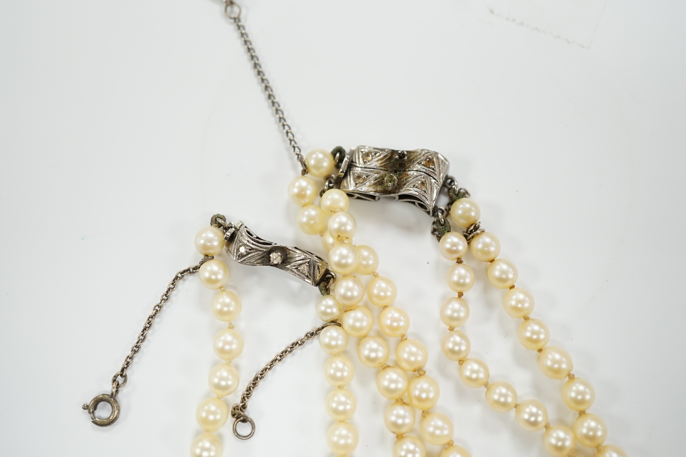 A double strand graduated cultured pearl necklace, with a white metal clasp, 48cm, together with a similar single strand graduated cultured pearl necklace